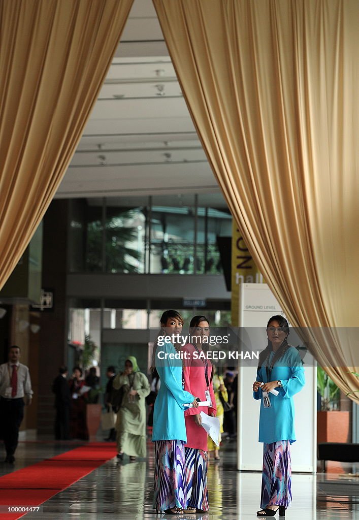 Traditionally dressed Malaysian hostesse