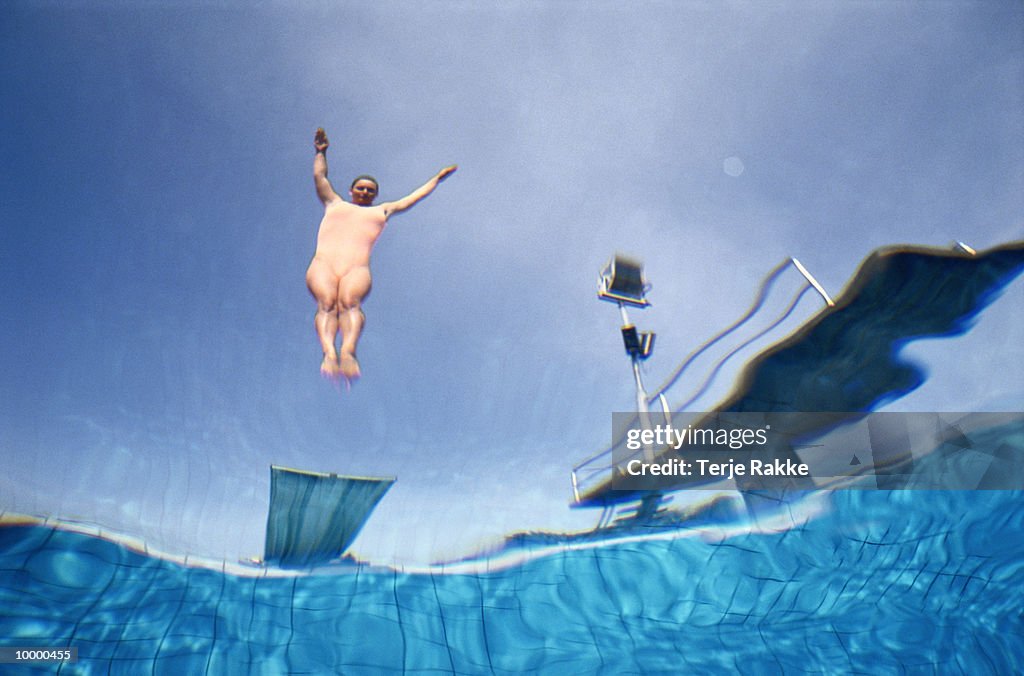 UNDERWATERVIEW OF A FEMALE DIVER IN MIDAIR