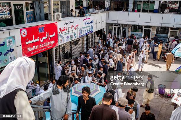 People gather at the money exchange market in Kabul, Afghanistan, on Thursday, July 12, 2018. U.S President Donald last year said 16,000 U.S. Troops...