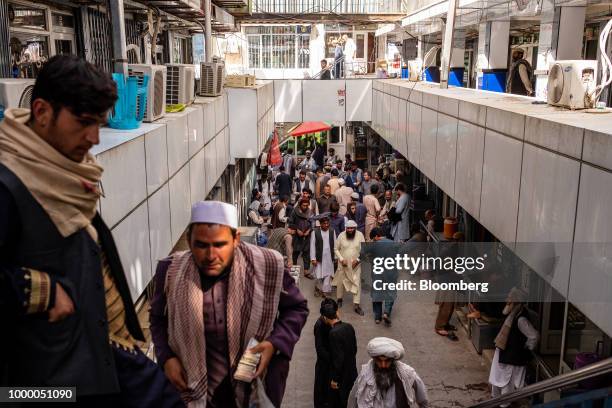 People gather at the money exchange market in Kabul, Afghanistan, on Thursday, July 12, 2018. U.S President Donald last year said 16,000 U.S. Troops...