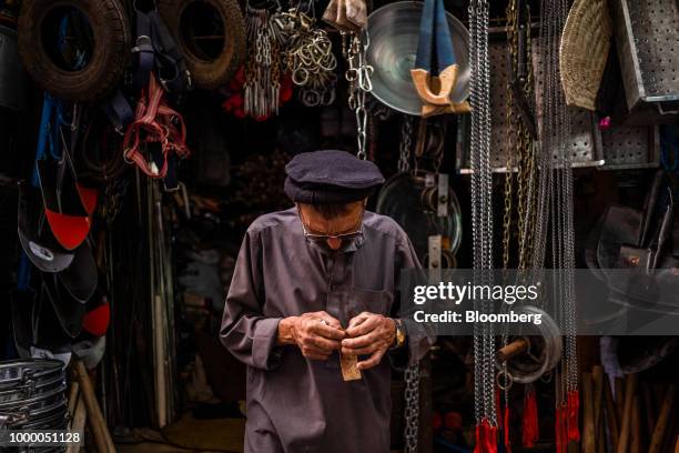 Man stands in front of a hardware store at Mandai Bazaar in Kabul, Afghanistan, on Thursday, July 12, 2018. U.S President Donald last year said...