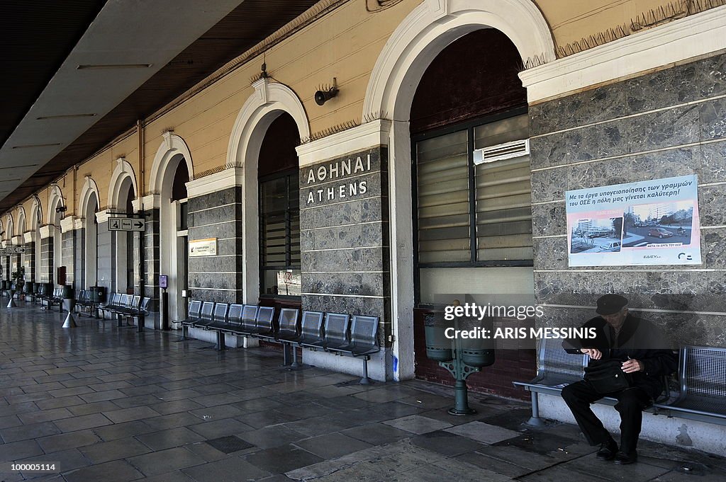 An eldery man sits at the empty Athens'