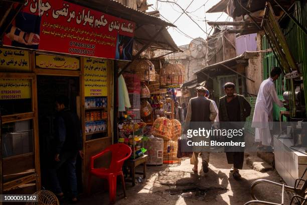 Pedestrians walk through an alley at the Kah Froshi bird market in Kabul, Afghanistan on Thursday, July 12, 2018. U.S President Donald last year said...