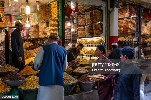 Customers browse dried fruits and nuts at a store at Mandai Bazaar in Kabul, Afghanistan, on Thursday, July 12, 2018. U.S President Donald last year...