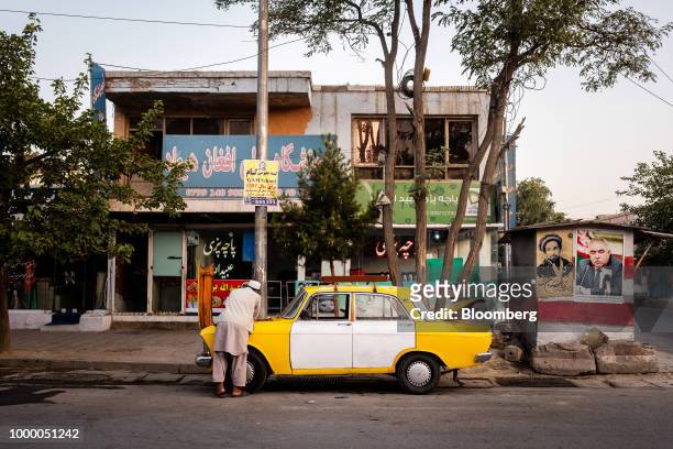 Taxi driver attends to his vehicle in Kabul, Afghanistan, on Sunday, July 15, 2018. U.S President Donald last year said 16,000 U.S. Troops would...