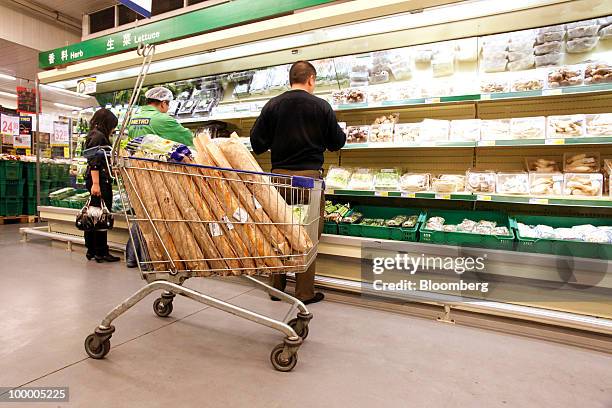 Customers shop at a Metro AG supermarket in Shanghai, China, on Wednesday, May 19, 2010. Metro AG, Germany's largest retailer, plans to add 100...