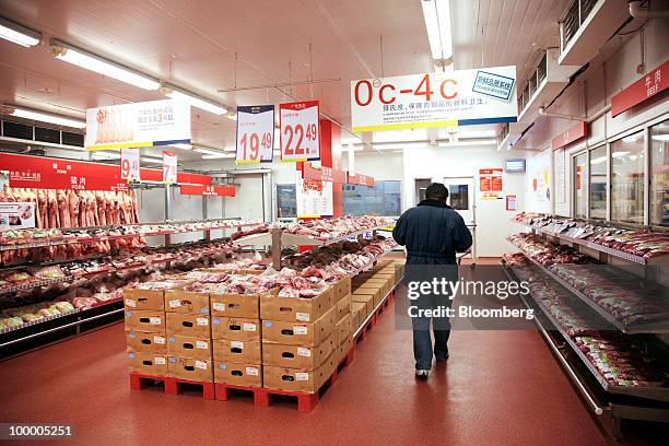 Customer shops in the meat section at a Metro AG supermarket in Shanghai, China, on Wednesday, May 19, 2010. Metro AG, Germany's largest retailer,...