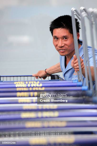 Staff member works at a Metro AG supermarket in Shanghai, China, on Wednesday, May 19, 2010. Metro AG, Germany's largest retailer, plans to add 100...