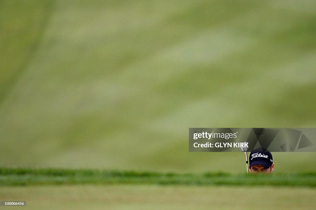 English golfer Ross Fisher prepares to p