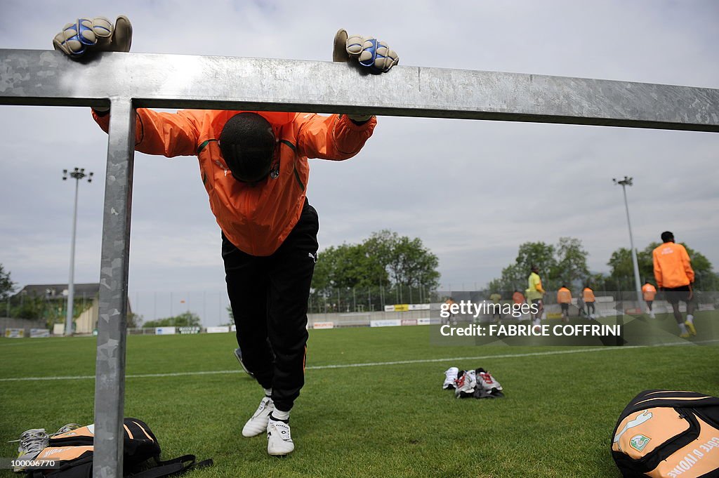 Ivory Coast football player streches pri