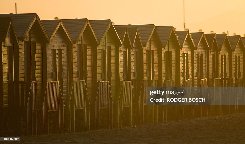 The sun rises on coloured bathing houses