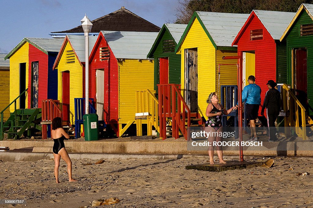 A woman takes a shower, after swimming,