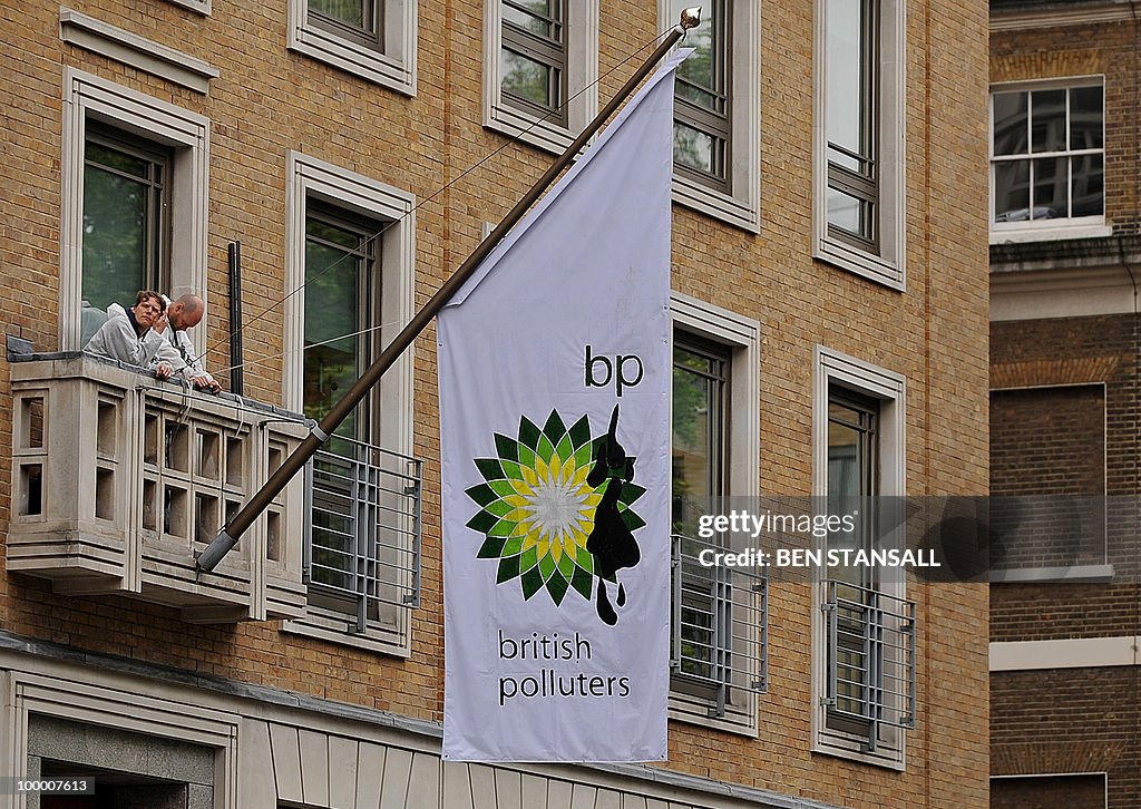 Greenpeace demonstrators, stand on a bal