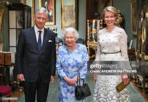 Britain's Queen Elizabeth II, Belgium's King Philippe and Belgium's Queen Mathilde pose in the Grand Corridor during their audience at Windsor...