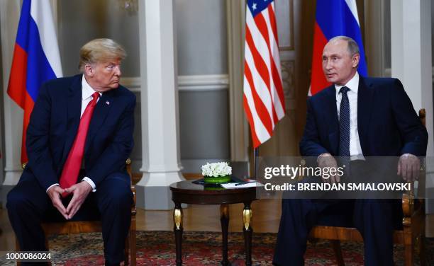 Russian President Vladimir Putin and US President Donald Trump pose ahead a meeting in Helsinki, on July 16, 2018.