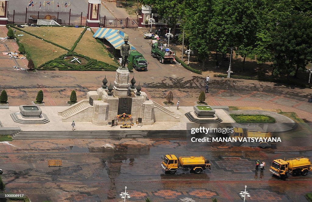 Thai workers clean roads inside the Red