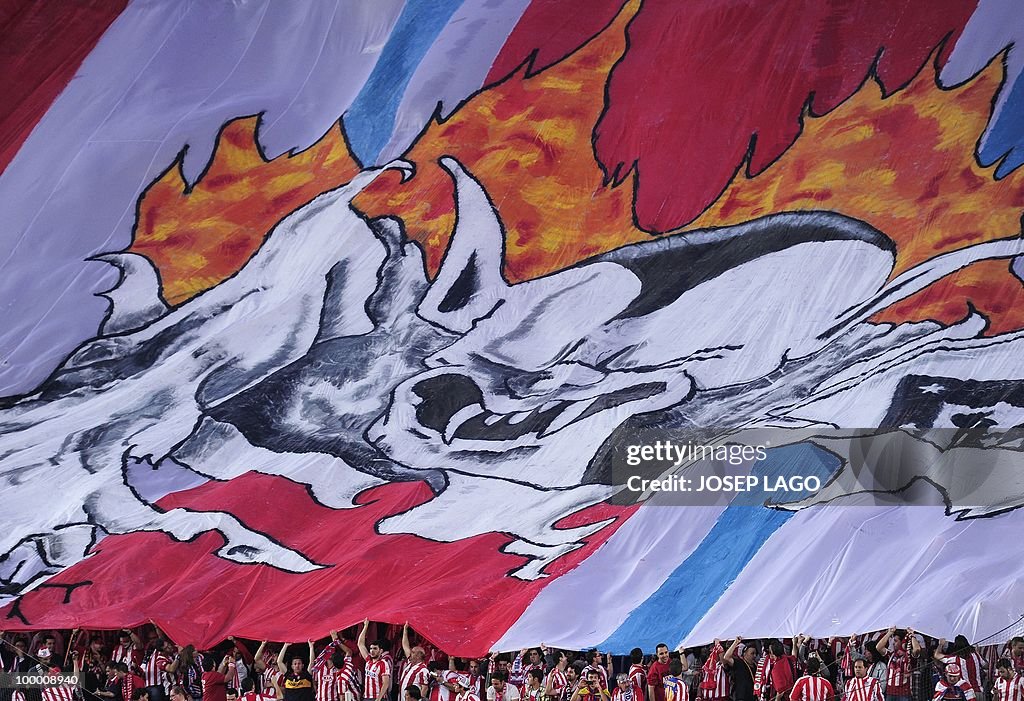 Atletico Madrid supporters cheer their t