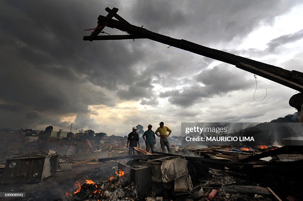 Residents look at the rubble during an e