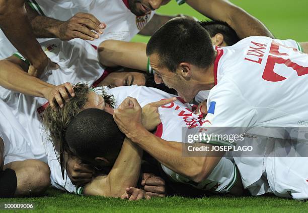 Sevilla's midfielder Diego Capel is congratuled by his teammates after scoring during the King's Cup final match Sevilla against Atletico Madrid at...