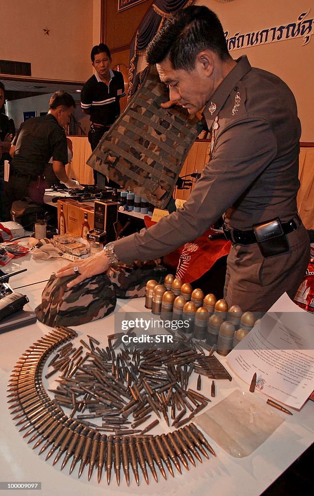 Thai policemen display weapons seized fr