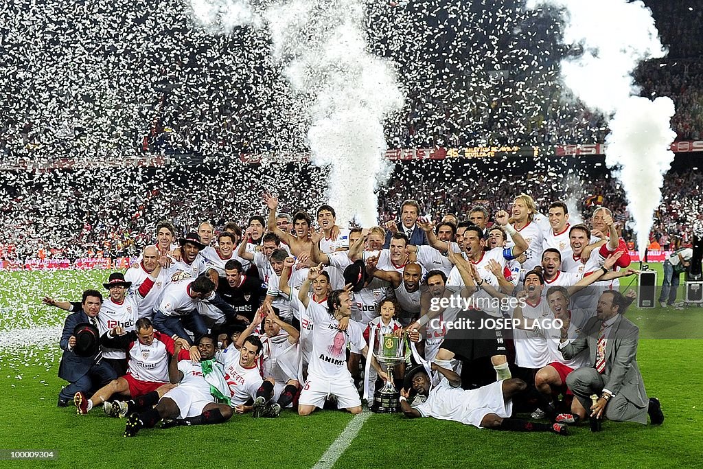 Sevilla's players celebrate with the tro