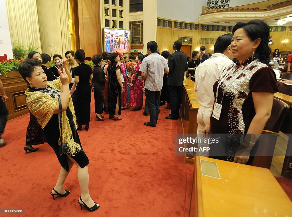Chinese women delegates take photos of e