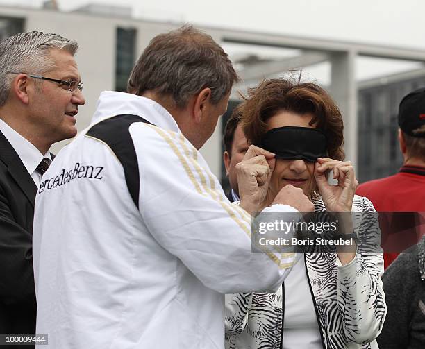 German head coach for blind football, Ulrich Pfisterer helps Dagmar Freitag, chairlady of the sports commission of the German Bundesta, to ware a...