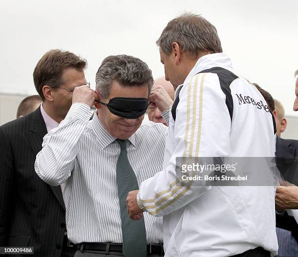 German head coach for blind football, Ulrich Pfisterer helps German Interior Minister Thomas de Maiziere to ware a mask on the �Day of Blind...