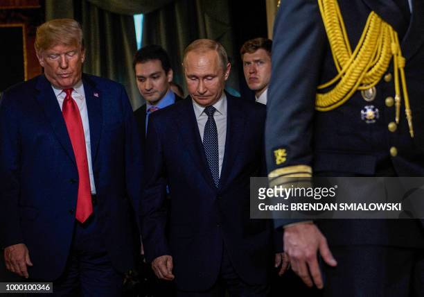 President Donald Trump and Russia's President Vladimir Putin arrive for a meeting at Finland's Presidential Palace on July 16, 2018 in Helsinki,...