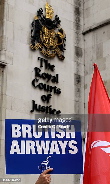 Member of British Airways cabin crew holds a placard as he awaits Unite's High Court appeal on a ban on strike action by BA cabin crew outside the...