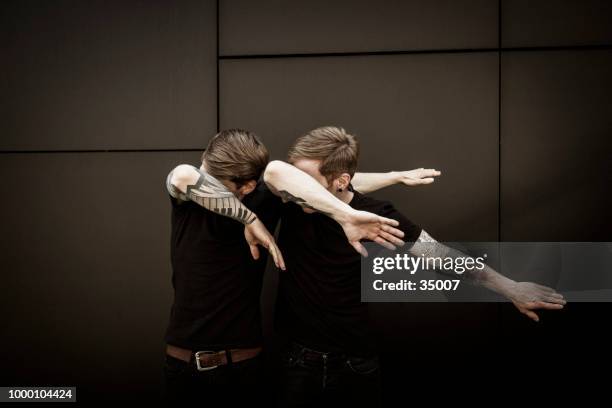 twin brothers doin the dab dance figure - dance routine stock pictures, royalty-free photos & images