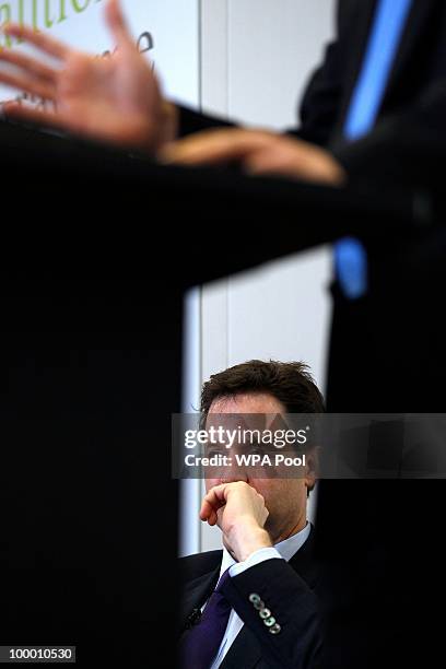Britain's Deputy Prime Minister Nick Clegg listens to Britain's Prime Minister David Cameron during the launch of the Government Programme Coalition...