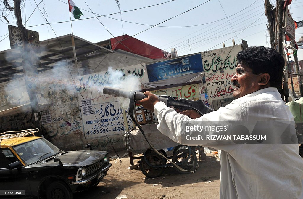 A Pakistani plain-clothes policeman fire