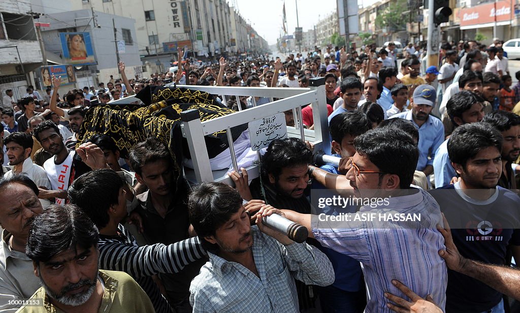 Pakistan relatives and residents carry a