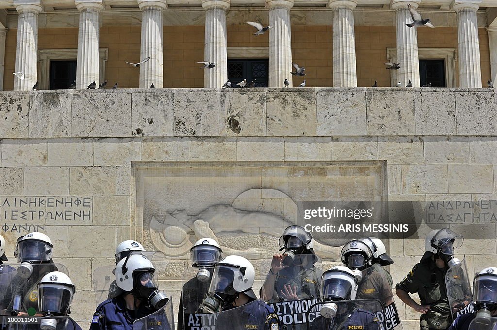 Greek riot police guard the tomb of the