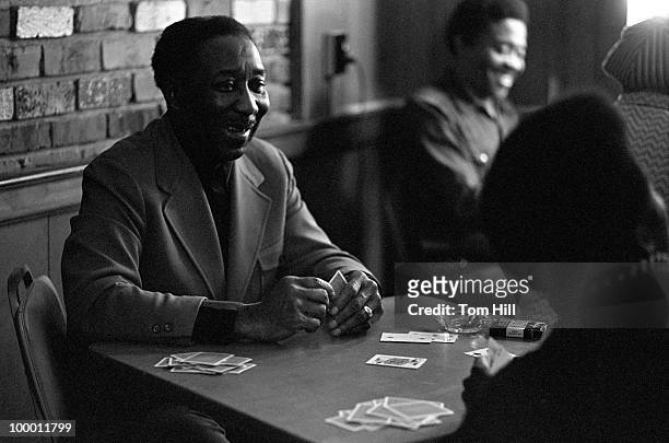 American Blues legend Muddy Waters plays cards with his band members backstage at Richards' Rock Club on May 29, 1972 in Atlanta, Georgia.