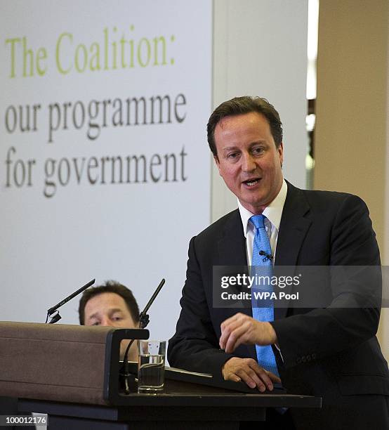 British Prime Minister David Cameron speaks during the launch of the Government Programme Coalition Agreement document as British Deputy Prime...