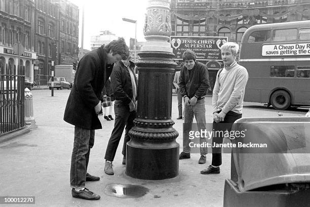 Portrait of British mod rock group Purple Hearts as they clown about in Soho, London, England, 1980. Pictured are, from left, guitarist Simon...