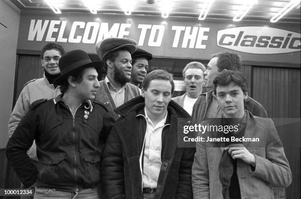 Portrait of British reggae group UB40 as they pose in front of the Classic cinema , Brimingham, England, 1981. Pictured are band members Ali Cambell,...