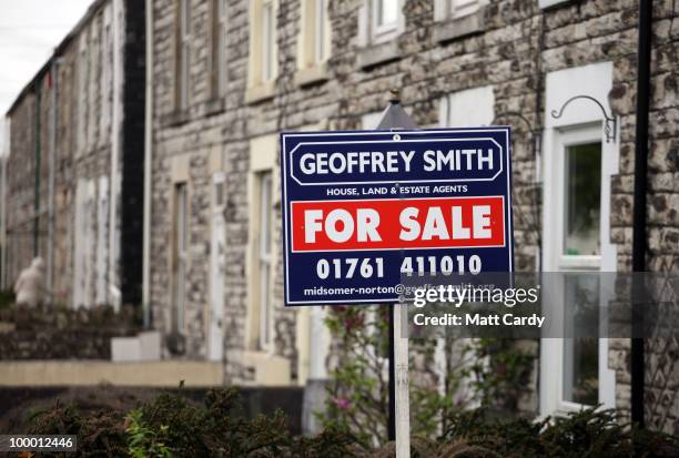 For sale signs are displayed outside houses on May 20, 2010 in Radstock, England. The new coalition government announced today, that as of midnight...