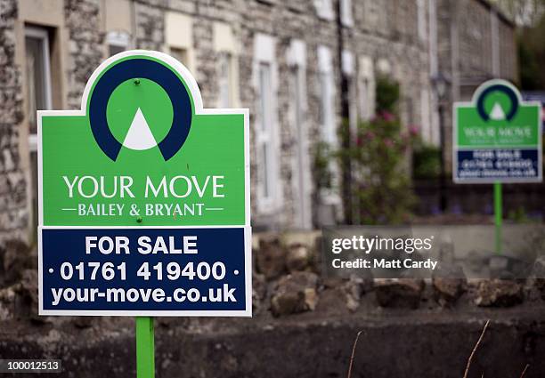 For sale signs are displayed outside houses on May 20, 2010 in Radstock, England. The new coalition government announced today, that as of midnight...