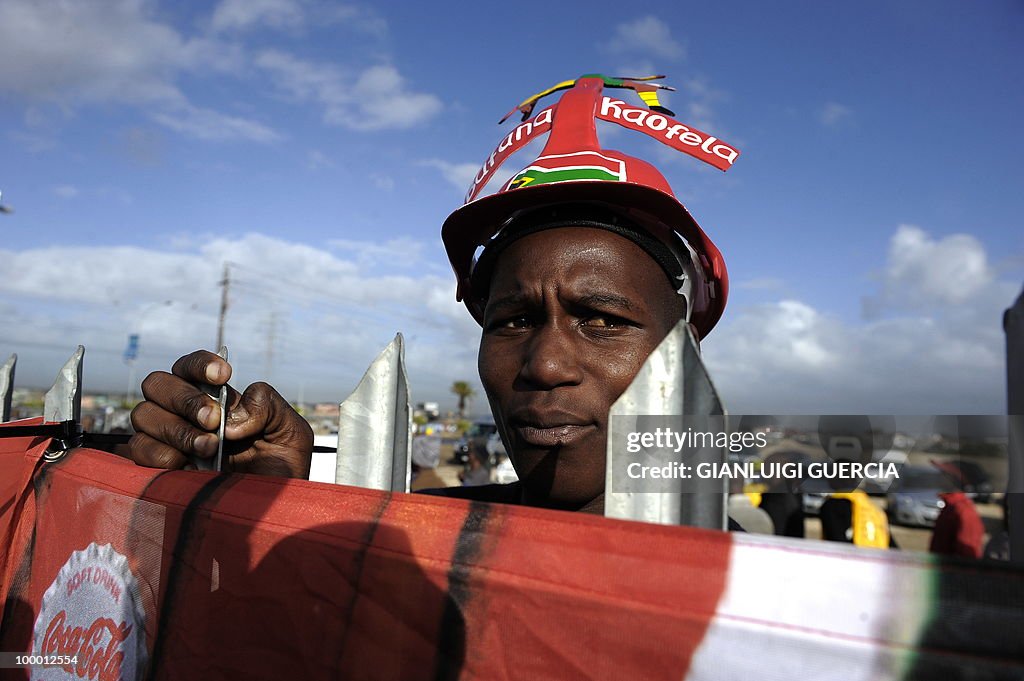 A South African football fan holds onto