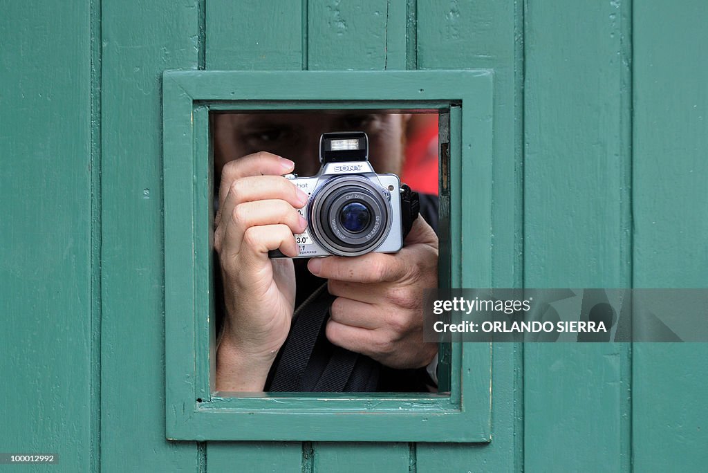 A Brazilian journalist takes pictures on