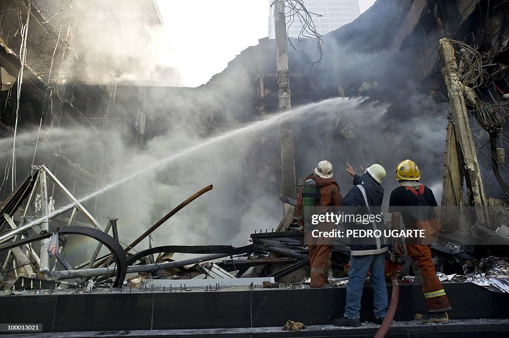 Thai firemen spray hoses on Thailand's b