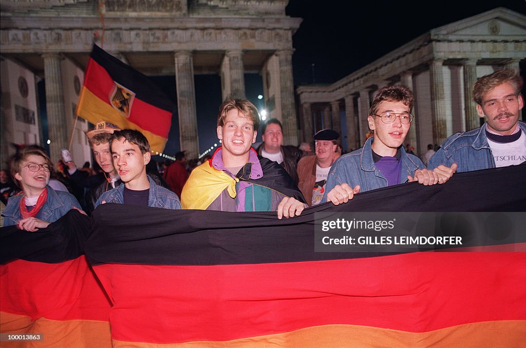 Berliner youths hold and wave German fla