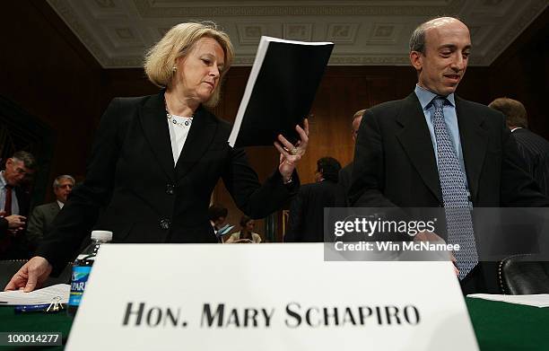 Securities and Exchange Commission Chairman Mary Schapiro and Commodity Futures Trading Commission Chairman Gary Gensler prepare for testimony before...