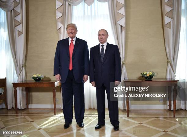 President Donald Trump and Russia's President Vladimir Putin pose ahead a meeting in Helsinki, on July 16, 2018. - The US and Russian leaders opened...