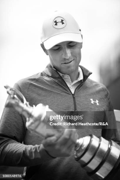 Jordan Spieth of the United States, winner of the 146th Open Championship, carries the Claret Jug onto the first tee as he returns it during previews...