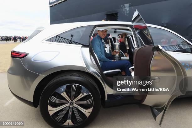 Jordan Spieth of the United States, winner of the 146th Open Championship, carries the Claret Jug onto the first tee as he returns it during previews...