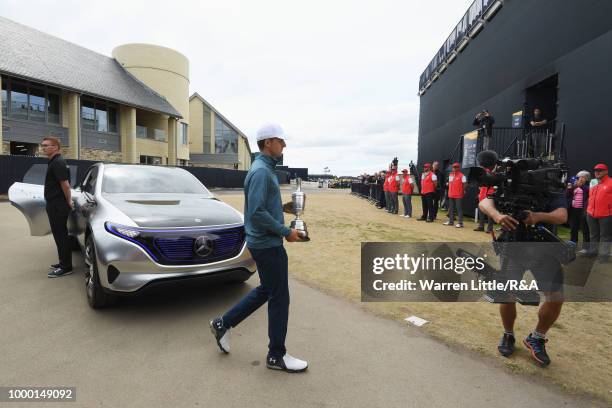 Jordan Spieth of the United States, winner of the 146th Open Championship, carries the Claret Jug onto the first tee as he returns it during previews...